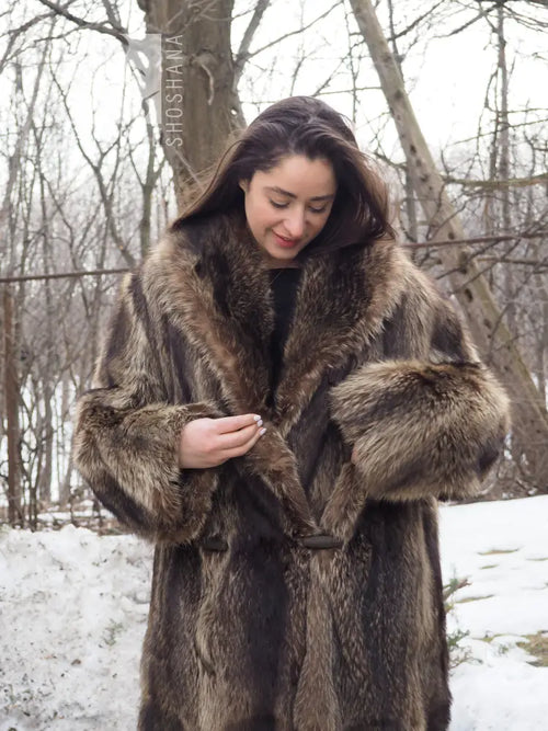 Reversible raccoon fur coat close-up: hooded collar, toggle fasteners, brown fur texture