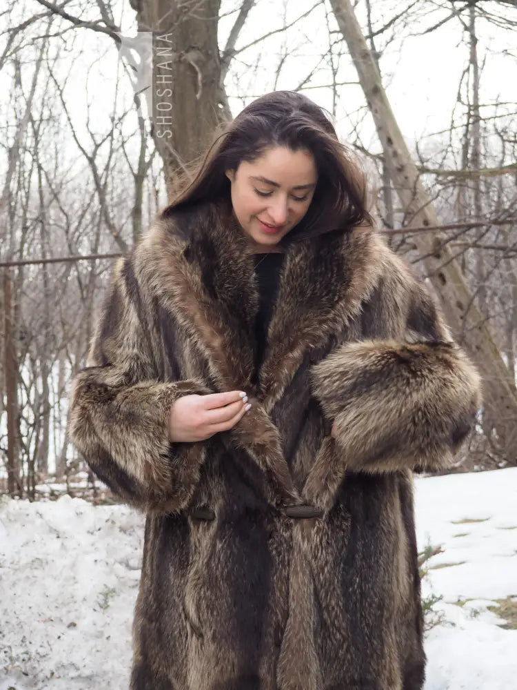 Reversible raccoon fur coat close-up: hooded collar, toggle fasteners, brown fur texture