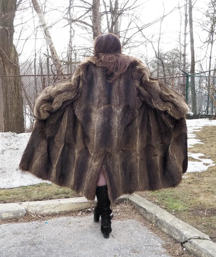 Long raccoon-fur coat back view with voluminous shoulders and full skirt hem