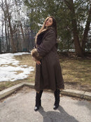 Reversible fur coat showing dark outer side with tan fur collar and cuff trim