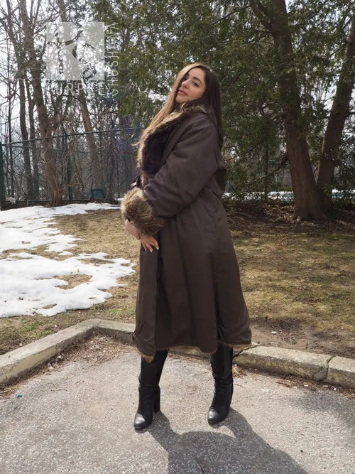 Reversible fur coat showing dark outer side with tan fur collar and cuff trim