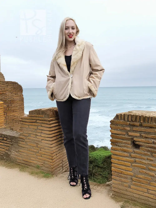 Tan mink fur jacket with cream sheared fur collar and front snap closure