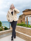 Light beige mink fur jacket with button front and plush collar, worn over black top