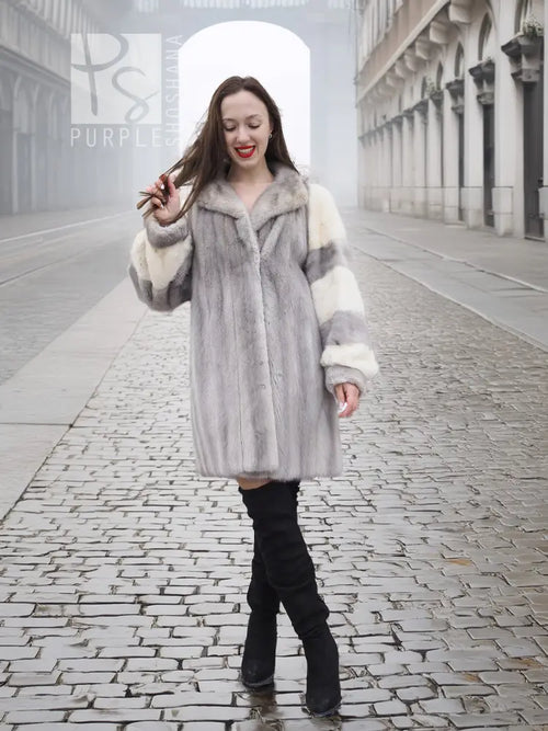 Light gray mink fur coat with wide collar and cream striped sleeves, knee-length