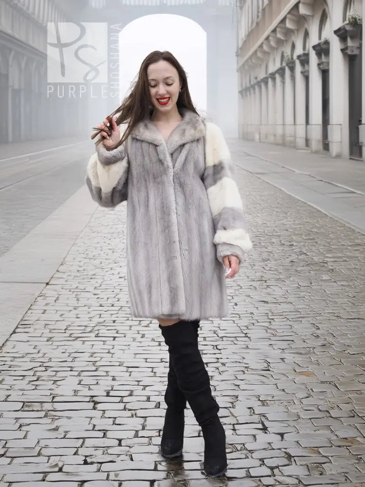 Light gray mink fur coat with wide collar and cream striped sleeves, knee-length