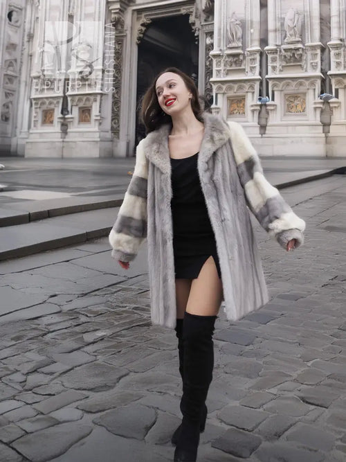 Mink fur coat with striped fur sleeves and flared shoulders, front view with arms out.