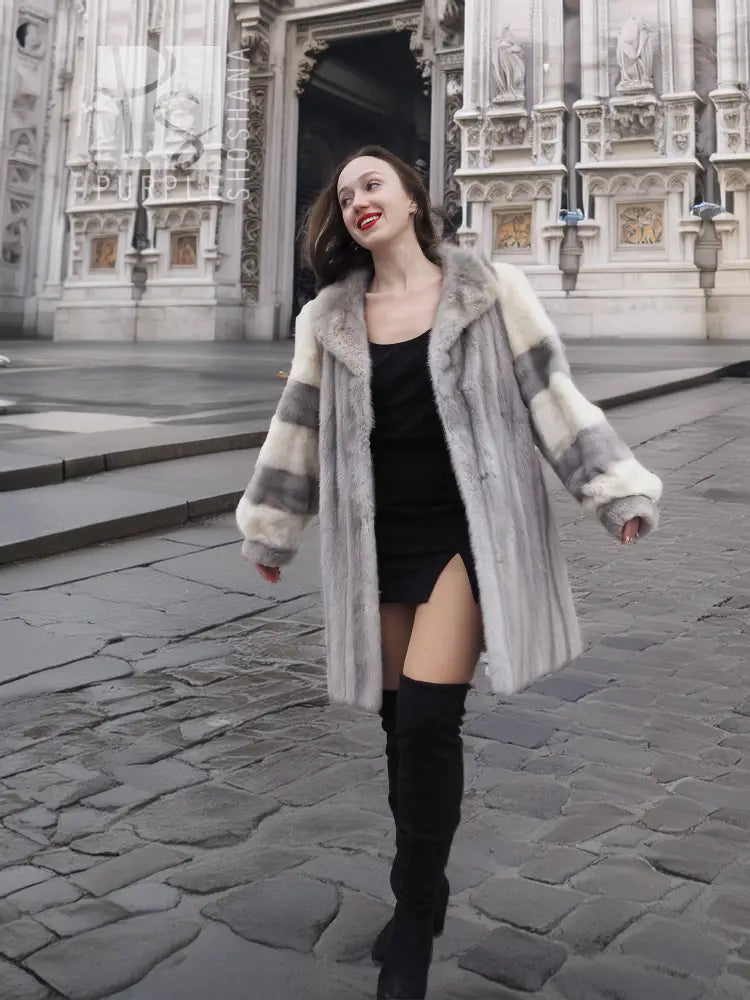 Mink fur coat with striped fur sleeves and flared shoulders, front view with arms out.