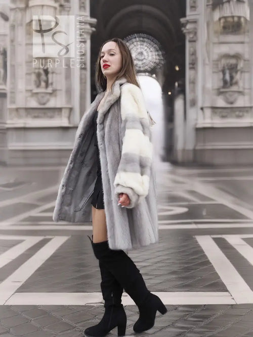 Mink fur coat with striped shoulder panels and thick fur cuffs, front walking pose.