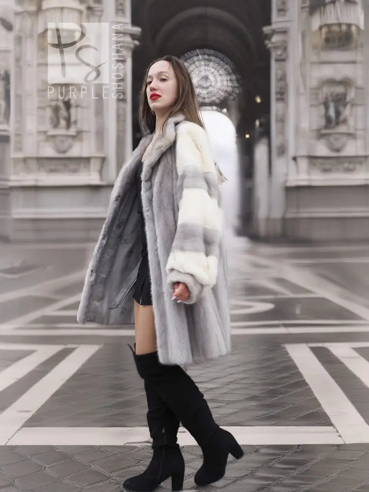 Mink fur coat with striped shoulder panels and thick fur cuffs, front walking pose.