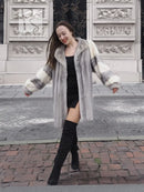 Light gray mink fur coat with cream cuffs and hood, open front, knee length