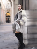 Mink fur coat with fur hooded collar effect and striped pockets, front three-quarter view.