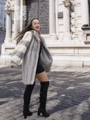 Mink fur coat with light striped sleeves and wide collar, front view with long hem.