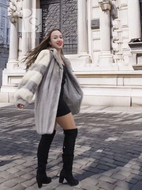 Mink fur coat with light striped sleeves and wide collar, front view with long hem.