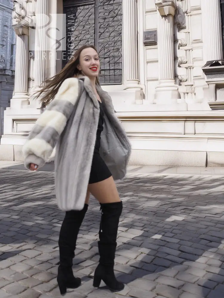 Mink fur coat with light striped sleeves and wide collar, front view with long hem.