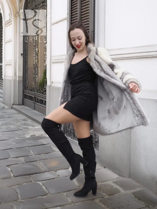 Mink fur coat with light gray fur and cream accent sleeves, worn over a black dress