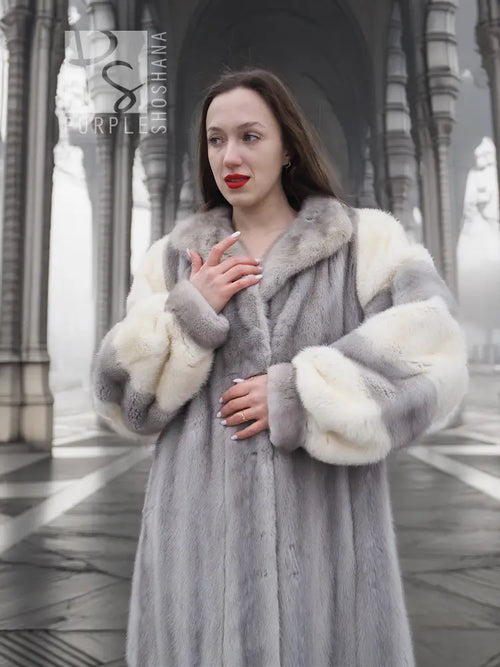 Mink fur coat with large fur cuffs and structured collar, buttoned front view.