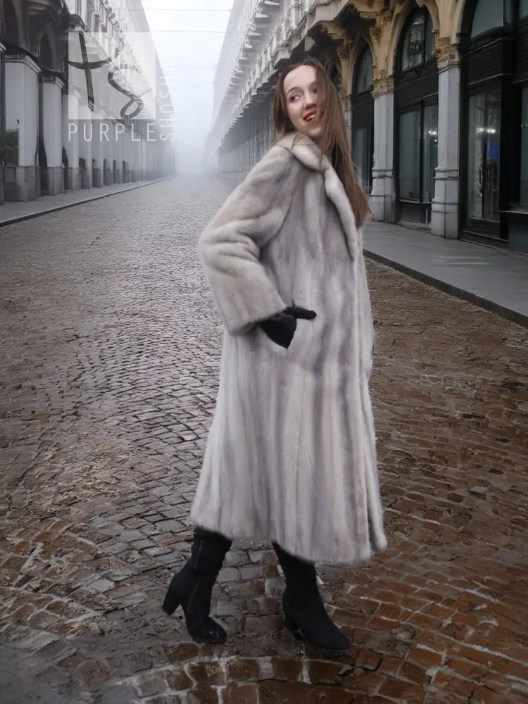 Grey mink fur coat with hooded neckline and long flared body, front view.
