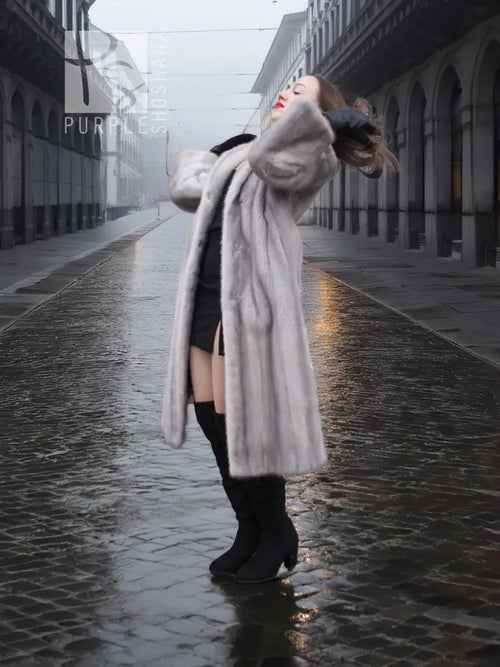 Light gray mink fur coat with hood, long sleeves, and open front with draped hem.