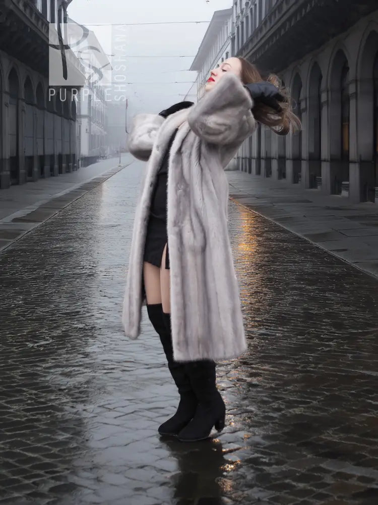 Light gray mink fur coat with hood, long sleeves, and open front with draped hem.