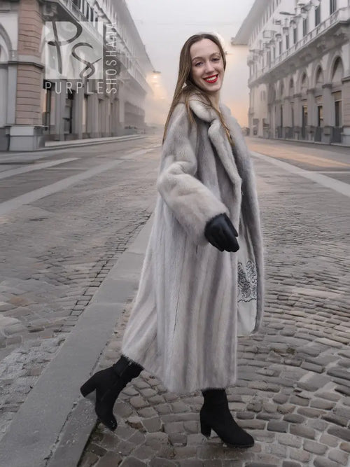 Light gray mink fur coat with hooded neckline, long sleeves, and open front detail.