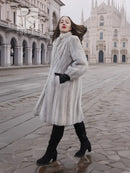 Light gray mink fur coat with stand collar, mid-thigh length, tied belt at waist