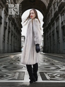 Light gray mink fur coat, long length with voluminous sleeves and black gloves.