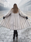 Light gray mink fur coat, back view with flared hem and wide sleeves.