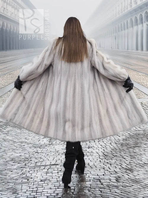 Light gray mink fur coat, back view with flared hem and wide sleeves.