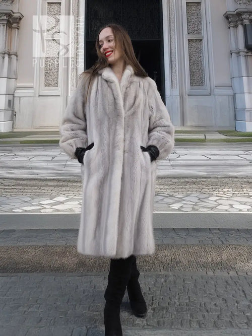 Light gray mink fur coat with stand collar and long sleeves, black cuffed gloves