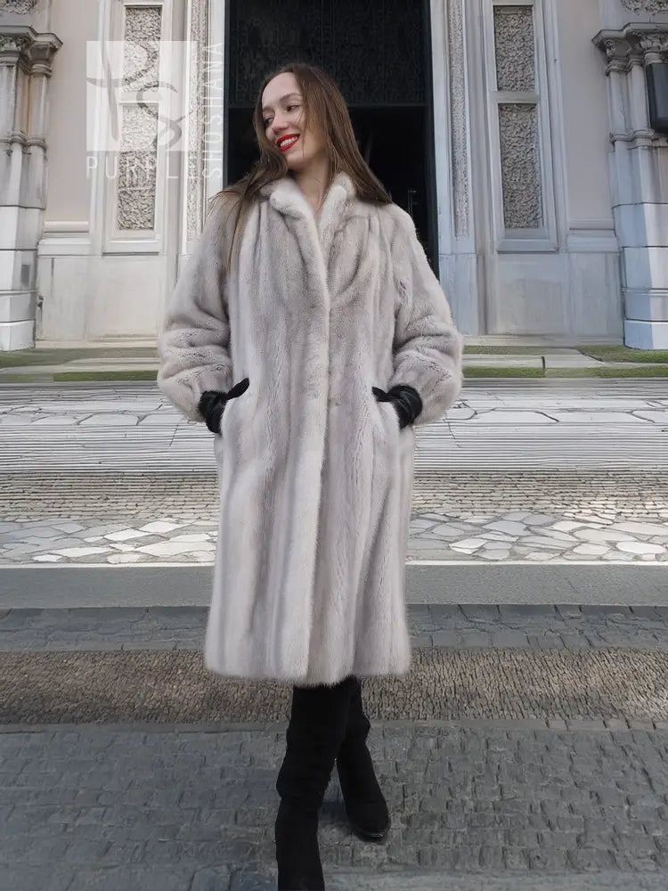 Light gray mink fur coat with stand collar and long sleeves, black cuffed gloves