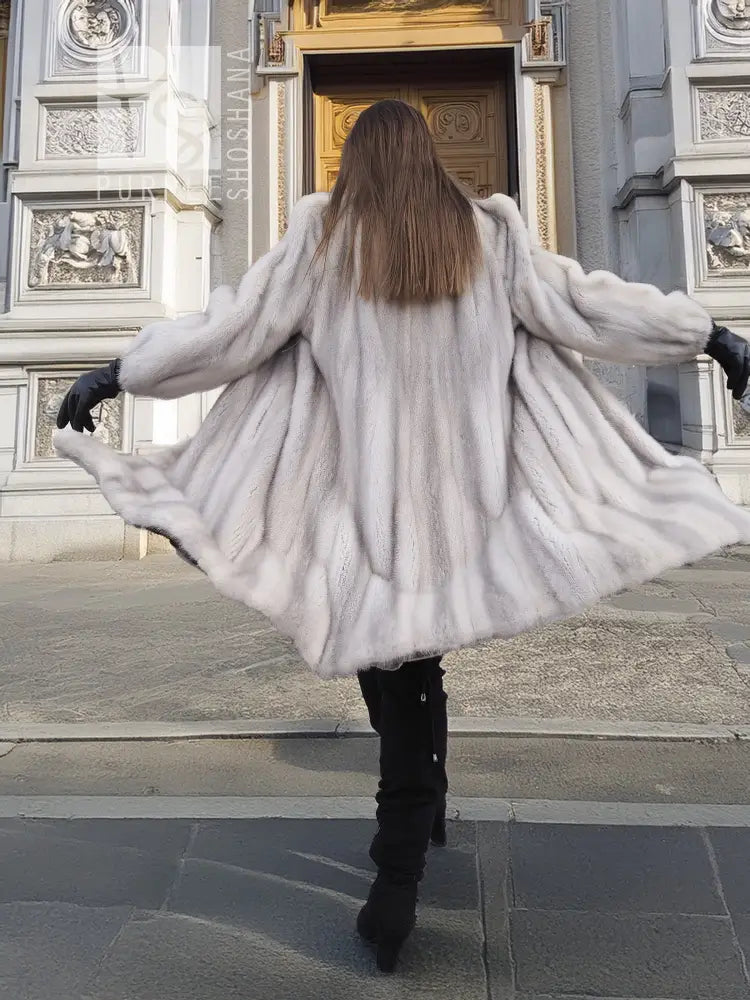 Light gray mink fur coat, rear view with flared hem and long sleeves