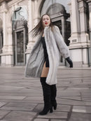 Light gray mink fur coat, open front with long sleeves and black gloves.
