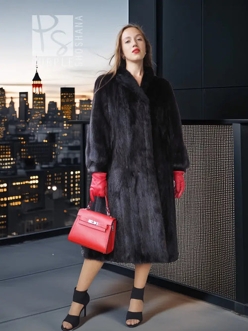Black mink fur coat with relaxed fit and wide fur cuffs, knee-length
