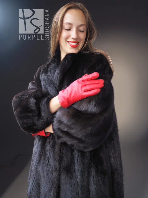 Black mink fur vintage coat close-up, full collar and red gloves