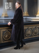 Black mink fur coat with fox fur collar, back/side view with one leg forward