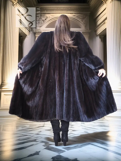 Back view of black mink fur coat with oversized flared hem and wide collar