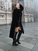 Black mink fur coat with hooded style, cropped view revealing zebra-pattern lining.
