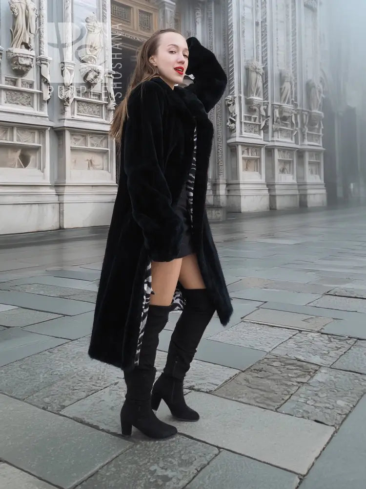 Black mink fur coat with hooded style, cropped view revealing zebra-pattern lining.
