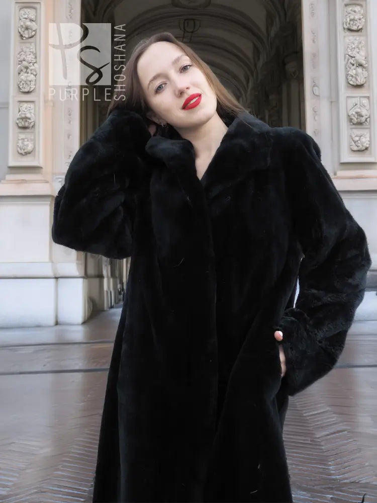 Dark mink fur coat with pointed collar and long sleeves, front view.