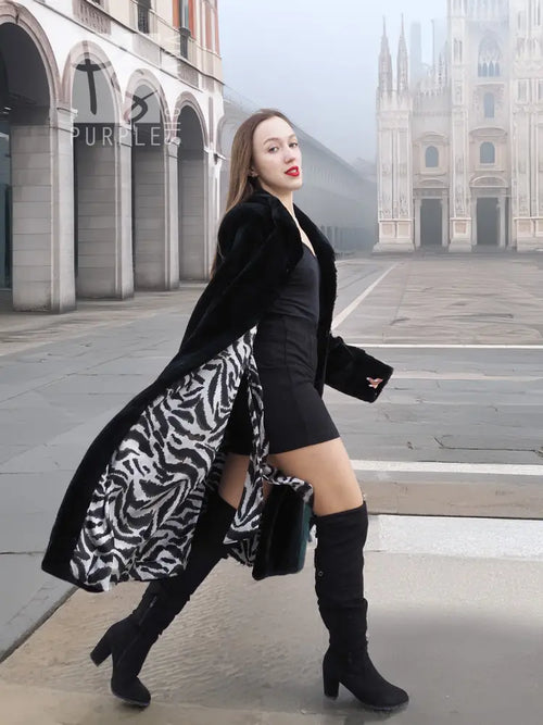 Dark mink fur coat with long sleeves and knee length, standing pose.