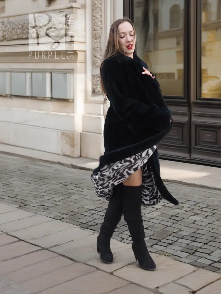 Black mink fur coat with long sleeves, front buttons, and knee-length hem.