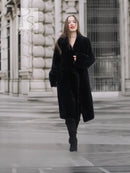 Black mink fur coat with V-neck, button front, long sleeves, and knee-length cut.