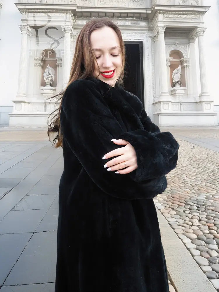 Dark mink fur coat with long sleeves and button-front, close portrait view.