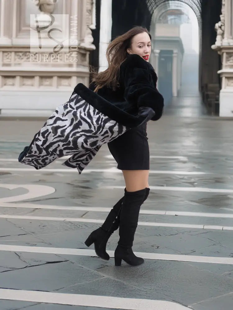 Mink fur coat, dark color, sleeves down with open hem showing zebra-print lining