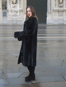 Mink fur coat, dark color, side view with long sleeves and straight hemline