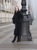 Mink fur coat, dark color, three-quarter front view with button-front and long fit