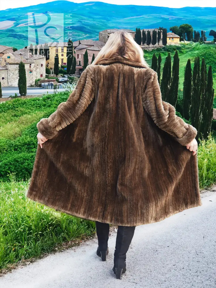 Back view of dark brown hooded fur coat, full length, swaying hem