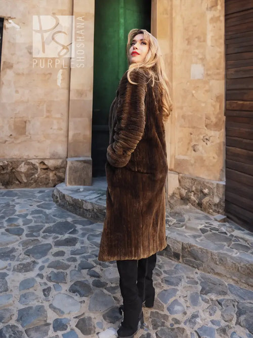 Sheared beaver fur coat in dark brown, full length with plush texture and stand collar