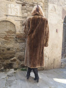 Back view of dark brown full-length fur coat with hood and vertical textured pattern