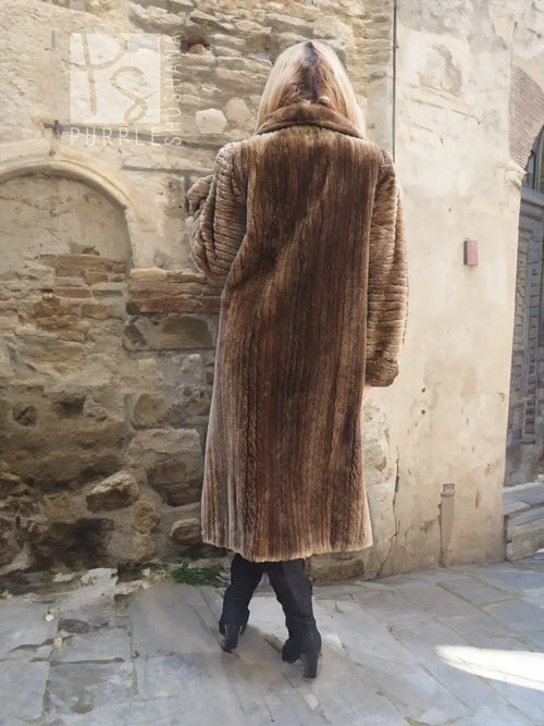 Back view of dark brown full-length fur coat with hood and vertical textured pattern